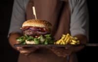 front-view-male-holding-tray-with-burger-fries